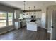 Bright kitchen with white cabinets, stainless steel appliances, island, and hardwood floors at 764 Oakleaf Dr, Greenfield, IN 46140