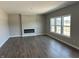 Open living room features hardwood floors, a modern fireplace, and large windows at 764 Oakleaf Dr, Greenfield, IN 46140