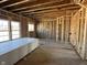 Interior view of a room under construction, revealing insulation and wooden framing, along with the window placement at 764 Oakleaf Dr, Greenfield, IN 46140