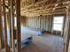 Framed room interior featuring exposed insulation and wooden beams, demonstrating the construction of the house at 764 Oakleaf Dr, Greenfield, IN 46140