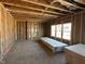 Unfinished room with wooden framing, insulation, and windows showcasing the construction phase of the house at 764 Oakleaf Dr, Greenfield, IN 46140
