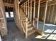 Unfinished wooden staircase with exposed framing, illustrating the construction process of the two-story home at 764 Oakleaf Dr, Greenfield, IN 46140