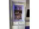 A bar area with a built in shelf unit, LED lighting, and storage at 802 N Meridian St # 205, Indianapolis, IN 46204