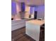 Modern white kitchen with stainless steel appliances, a center island, and custom LED lighting at 802 N Meridian St # 205, Indianapolis, IN 46204