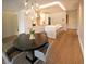 A modern kitchen with an ornate lighting fixture above a dining table in an open floor plan at 802 N Meridian St # 205, Indianapolis, IN 46204
