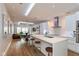Modern kitchen with sleek white cabinetry, stainless steel appliances, island with bar seating, hardwood floors at 802 N Meridian St # 205, Indianapolis, IN 46204