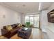 Inviting living room with hardwood floors, leather sofa, stylish decor, and natural light at 802 N Meridian St # 205, Indianapolis, IN 46204