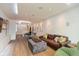 Open-concept living space with hardwood floors, modern lighting, and a leather couch with stylish pillows at 802 N Meridian St # 205, Indianapolis, IN 46204