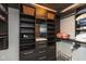 Well-organized walk-in closet with dark wood shelving and drawers for ample storage space at 802 N Meridian St # 205, Indianapolis, IN 46204