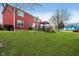 Expansive backyard with lush lawn, a charming patio under a pergola, and mature trees at 8238 Armadale Ct, Indianapolis, IN 46236