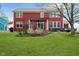 A spacious backyard with a well-maintained lawn, garden area, and a cozy patio under a pergola at 8238 Armadale Ct, Indianapolis, IN 46236