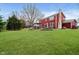Large backyard with green lawn, landscaping and patio space, perfect for outdoor activities and relaxation at 8238 Armadale Ct, Indianapolis, IN 46236