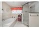 Bathroom features a large soaking tub and glass-enclosed shower for a spa-like experience at 8238 Armadale Ct, Indianapolis, IN 46236