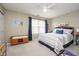 Bright bedroom featuring a ceiling fan, natural light, and minimalist furnishings at 8238 Armadale Ct, Indianapolis, IN 46236