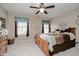 Comfortable bedroom with a ceiling fan, natural light, and traditional furnishings at 8238 Armadale Ct, Indianapolis, IN 46236