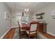 Elegant dining room featuring hardwood floors, tray ceiling, chandelier, and a large window at 8238 Armadale Ct, Indianapolis, IN 46236