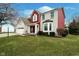 Beautiful home with lush green lawn, complemented by mature trees and attractive brick and siding exterior at 8238 Armadale Ct, Indianapolis, IN 46236