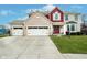 Charming brick and siding home featuring a three-car garage, well-manicured lawn, and inviting front entrance at 8238 Armadale Ct, Indianapolis, IN 46236