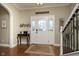 Inviting foyer with hardwood floors, elegant staircase, decorative table, and charming entryway at 8238 Armadale Ct, Indianapolis, IN 46236