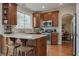 Spacious kitchen featuring granite countertops, breakfast bar, stainless steel appliances, and hardwood flooring at 8238 Armadale Ct, Indianapolis, IN 46236