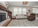Bright living room with fireplace, hardwood floors, and large windows for natural light at 8238 Armadale Ct, Indianapolis, IN 46236