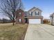 Traditional two-story home boasting a brick and siding facade, two-car garage, and a well-maintained lawn at 8430 Templederry Dr, Brownsburg, IN 46112