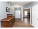 Inviting foyer showcasing wood flooring, a decorative dresser, and a view into a bright office space at 8430 Templederry Dr, Brownsburg, IN 46112