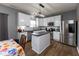 Well-lit kitchen featuring stainless steel appliances, dark countertops, and white cabinets at 8430 Templederry Dr, Brownsburg, IN 46112