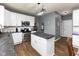 Modern kitchen with white cabinets, stainless steel appliances, a center island, and stylish lighting at 8430 Templederry Dr, Brownsburg, IN 46112