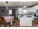 Bright eat-in kitchen with stainless appliances, dark countertops, and modern light fixtures at 8430 Templederry Dr, Brownsburg, IN 46112