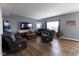 Comfortable living room with wood floors, leather reclining furniture, and a cozy atmosphere at 8430 Templederry Dr, Brownsburg, IN 46112