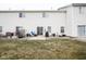 A backyard patio with a grill, seating, and a well-maintained lawn at 9769 Green Knoll Dr, Noblesville, IN 46060