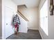 Entryway featuring light gray flooring, white walls, stairs to the second story, and a coat rack at 9769 Green Knoll Dr, Noblesville, IN 46060
