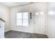 Bright entryway featuring light gray flooring, white walls, a window and traditional white front door at 9769 Green Knoll Dr, Noblesville, IN 46060