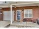 Close up shot of the front entry with brick facade, attached garage, and covered entrance at 9769 Green Knoll Dr, Noblesville, IN 46060