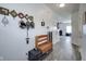 Hallway with light gray flooring, white walls decorated with photos, and furniture at 9769 Green Knoll Dr, Noblesville, IN 46060