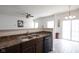 A kitchen sink and countertop overlooking the eat-in kitchen and light gray wood-look floors at 9769 Green Knoll Dr, Noblesville, IN 46060