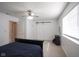 Bright main bedroom featuring a ceiling fan, a sliding barn door and ensuite at 9769 Green Knoll Dr, Noblesville, IN 46060
