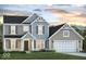 Charming two-story home featuring a mix of siding, gray shutters, gabled rooflines and a two-car garage at Vacant Lot 0 - 5750 W 650 N, Thorntown, IN 46071