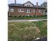 Durable brick home with manicured landscaping and brick-paved sidewalk along the side at 1001 S Anderson St, Elwood, IN 46036