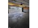 Spacious garage with an open door, concrete floor, and visible neighborhood views at 1001 S Anderson St, Elwood, IN 46036