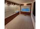 Bright sun room featuring large windows, carpeted floors, and wood trim at 1001 S Anderson St, Elwood, IN 46036