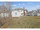 View of the backyard and white house with brick chimney at 1023 W 7Th St, Anderson, IN 46016