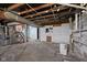 Spacious unfinished basement with concrete floors, utility hook ups, and exposed beams at 1023 W 7Th St, Anderson, IN 46016