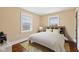 Comfortable bedroom featuring gleaming hardwood floors and sun-filled windows at 1023 W 7Th St, Anderson, IN 46016