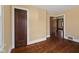 Bedroom featuring hardwood floors, neutral walls, and a view into the hall at 1023 W 7Th St, Anderson, IN 46016