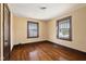 This bedroom boasts hardwood floors and natural light from two windows at 1023 W 7Th St, Anderson, IN 46016