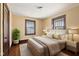 Comfortable bedroom featuring a plush bed, hardwood floors, and bright natural light at 1023 W 7Th St, Anderson, IN 46016