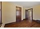 Bedroom featuring hardwood floors, neutral walls, and a view into the hall at 1023 W 7Th St, Anderson, IN 46016
