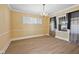 A bright dining room with neutral walls, wood-look floors, and a classic chandelier at 1023 W 7Th St, Anderson, IN 46016